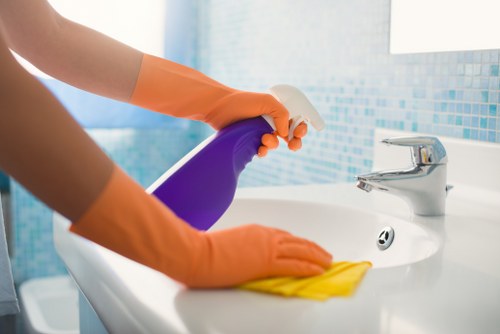 Technician preparing carpet cleaning equipment in a safe home environment